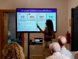 Presentadora explicando prevención de caídas a pacientes con Parkinson